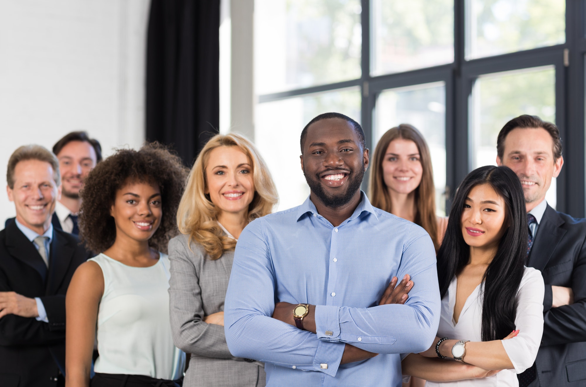 African American Businessman Boss With Group Of Business People In Creative Office, Successful Mix
